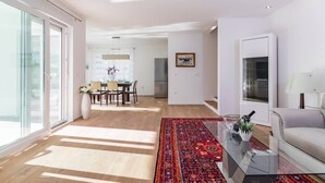 A spacious living area with a dining table, a sofa, and a glass coffee table. - Beautiful Villa with swimming-pool in Pula Croatia (Pula)