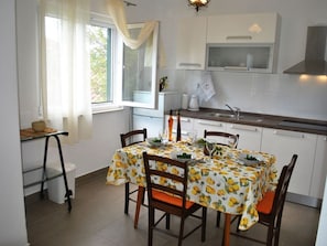 Enjoy meals in the kitchen with a modern sink and dining area for four.