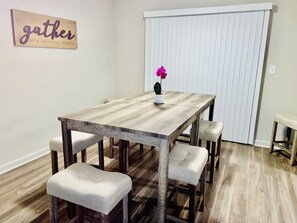 Gather with friends and family in this cozy dining area, featuring a rustic table and comfortable benches.