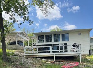 A two-story house with a covered porch and a garage.