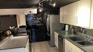 A modern kitchen with stainless steel appliances, a built-in oven, and a large island. - Lake of Egypt Cove - Waterfront Home, Kayaks, Pet Friendly (Creal Springs)