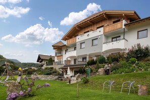 A multi-story building with balconies, a play area, and a garden. - Holiday Apartment "Stefansdorf Wohnung 8" with Mountain View, Wi-Fi, Garden, Balcony and BBQ (St. Lorenzen)
