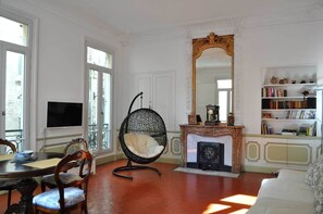 TV connectée, cheminée, livres, chaîne hi-fi