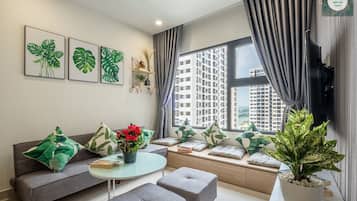 Deluxe Apartment | Living area | 55-inch flat-screen TV with cable channels, TV