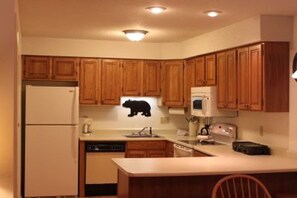 Enjoy cooking in this well-equipped kitchen with a dishwasher, refrigerator, microwave, and toaster.