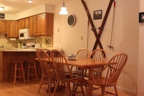 Cozy kitchen with microwave and refrigerator, perfect for food preparation and casual dining.