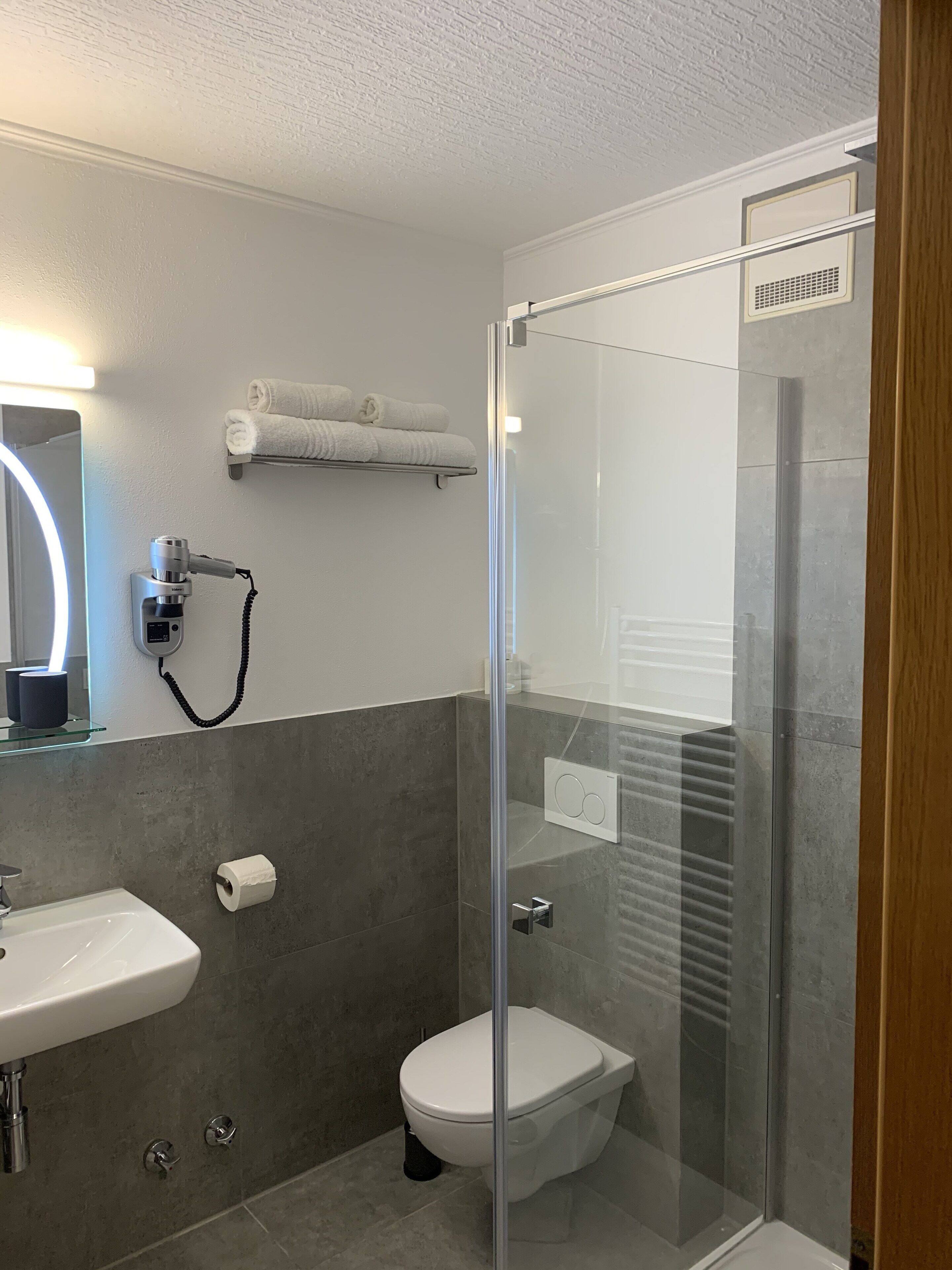 Shower, rainfall showerhead, hair dryer, towels