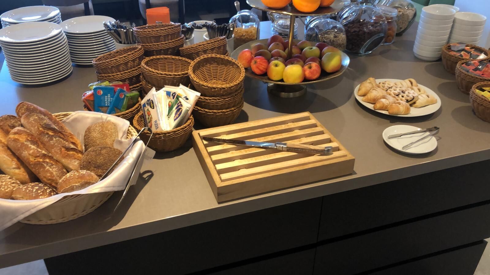 A buffet setup with various food items and utensils.