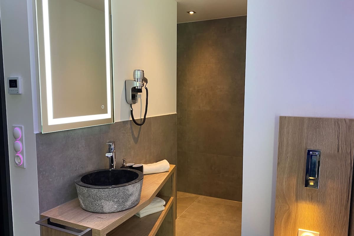 comfort single room | bathroom | shower, rainfall showerhead, hair dryer, towels