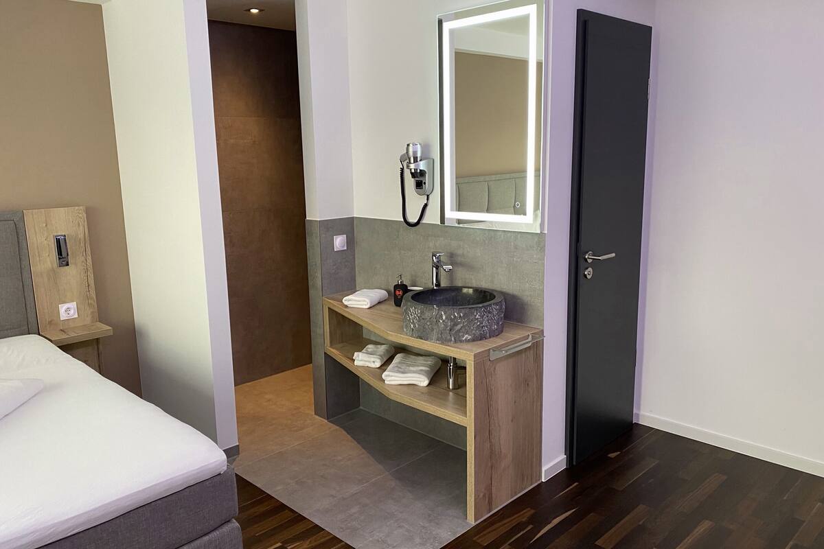 comfort single room | bathroom | shower, rainfall showerhead, hair dryer, towels