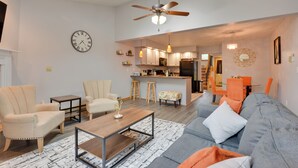 A modern living room with a sofa, chairs, a coffee table, and a kitchen in the background. - Oakland Vacation Rental < 1 Mi to Deep Creek Lake! (Oakland)