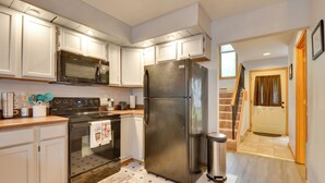 A modern kitchen with white cabinets, stainless steel appliances, and a wooden countertop. - Oakland Vacation Rental < 1 Mi to Deep Creek Lake! (Oakland)