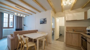 A modern apartment with a dining area, kitchenette, and a living room with a sofa and chairs. - 🎖 Le Parmelan - apartment for 2 people in the heart of the old town (Annecy)