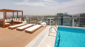 A rooftop pool area with lounge chairs and a wooden pergola. - w* | Amazing Loft in Barranco (Barranco)