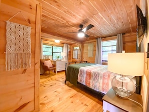 Relax in this inviting bedroom with a comfortable bed, bedside lamp, and desk area.