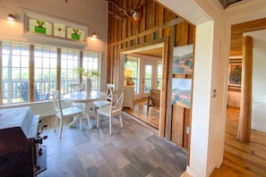 Relax in this open-plan living space with a large dining table and comfortable seating area.