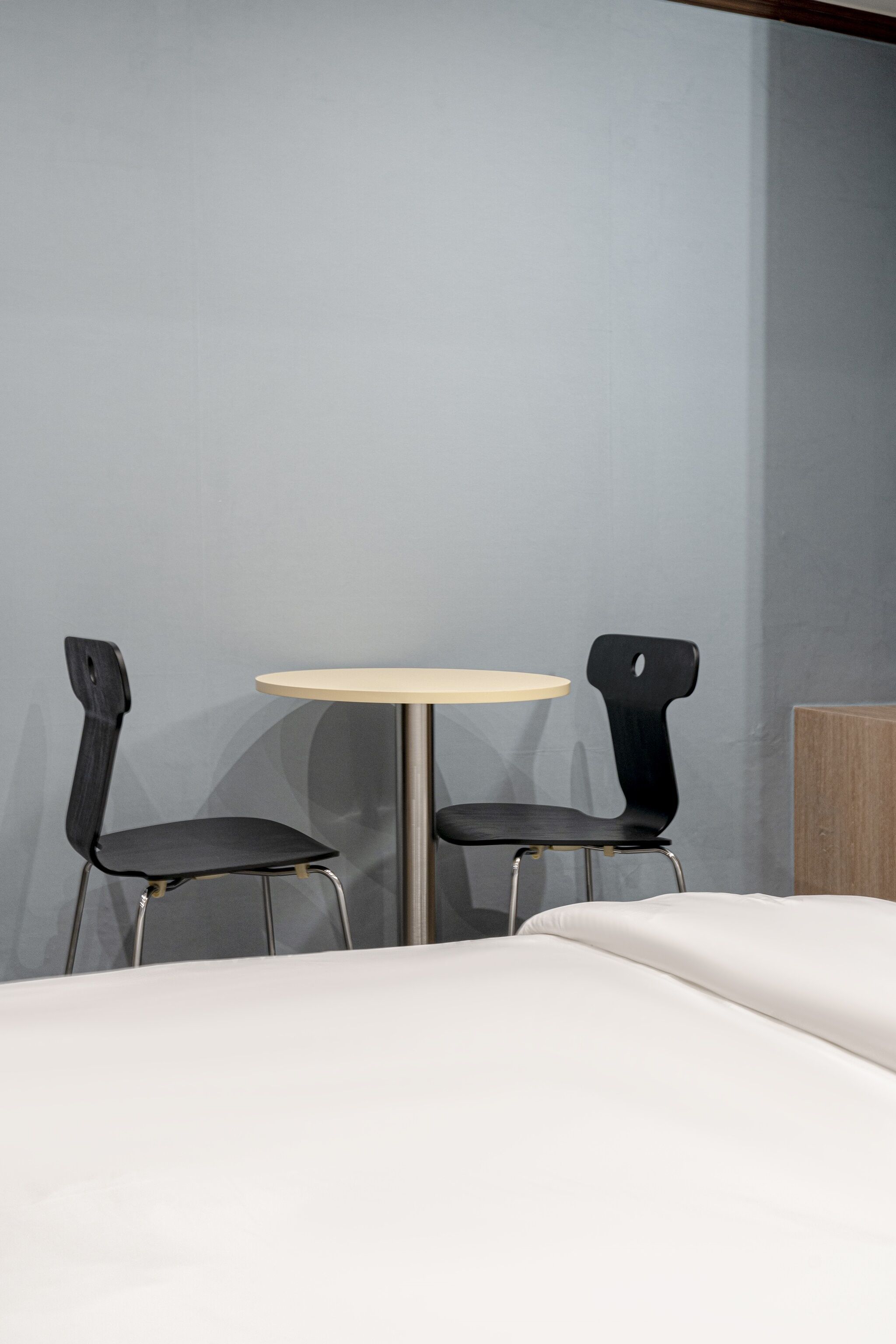 A room with a round table and two chairs.