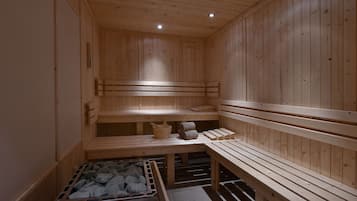 A wooden sauna with benches and a stone-filled container, likely for heating.
