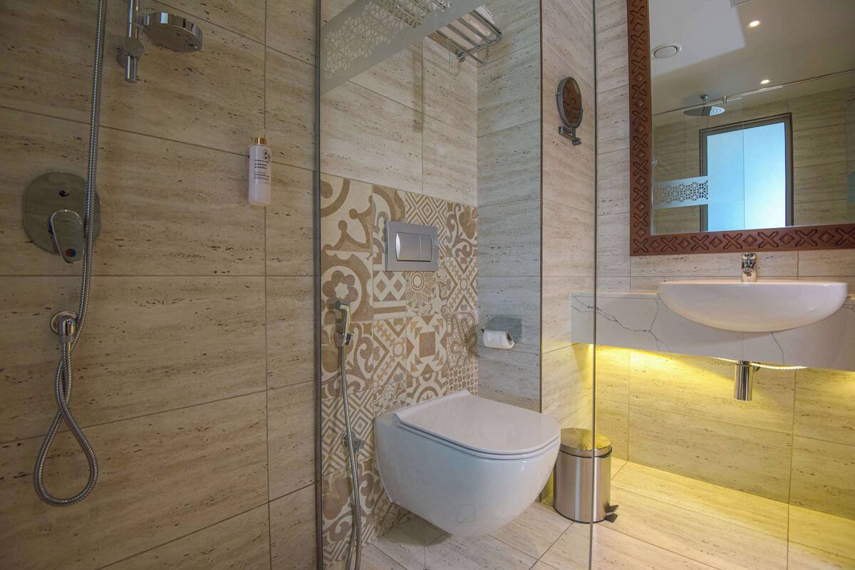 rainfall showerhead, eco-friendly toiletries, hair dryer, slippers