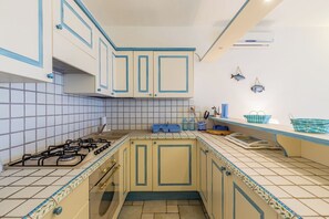 Fridge, coffee/tea maker, cookware/dishes/utensils, dining tables