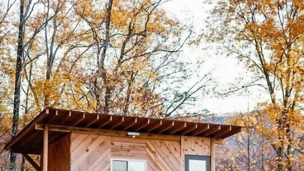 A wooden cabin with a balcony, a porch, and a small deck area. - “The Summit Cabin” <br>An Off the Grid Hideaway (Barnardsville)