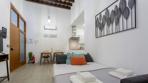 A compact bedroom with a bed, bedside table, and a small kitchenette. - CRUISE Adapted Apartment by Cadiz4Rentals (Cádiz)