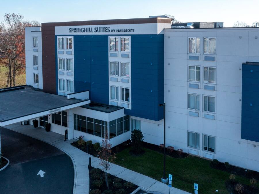 A modern hotel with a clear sign reading "SPRINGHILL SUITES BY MARRIOTT".