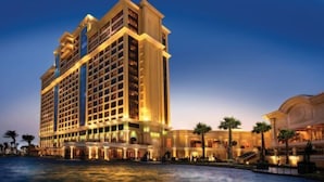 A multi-story hotel with a pool in front, featuring a grand entrance and multiple balconies. - InterContinental Grand Ho Tram (Ho Chi Minh City)