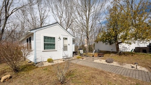 A small, single-story house with a front porch and a small garden area. - Relaxing Getaway with Town Beach Access (Westerly)