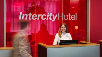 A reception desk with a sign reading "Intercity Hotel" in the background.