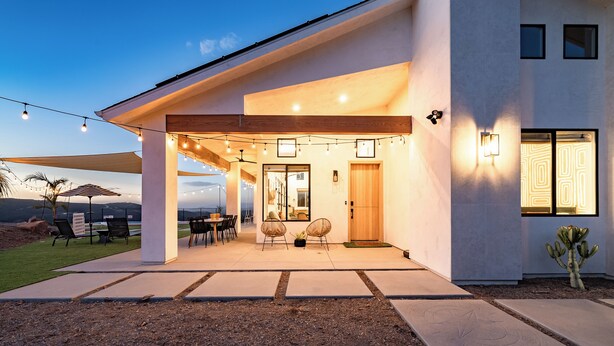A modern house with a covered patio, outdoor seating, and a view of the landscape. - Holiday Escape!!! Pool, Hot Tub, Game Room, Fire Pit (Vista)