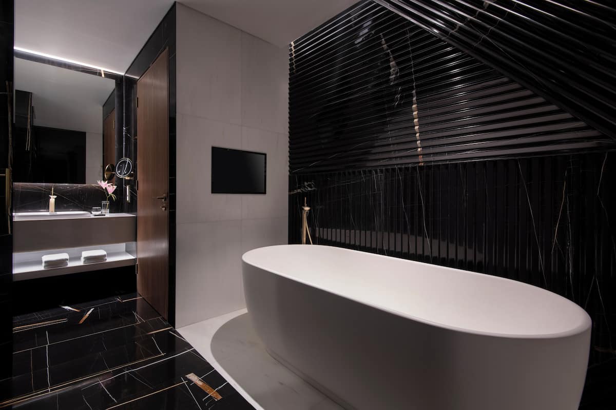 executive suite | bathroom | rainfall showerhead, designer toiletries, hair dryer, slippers