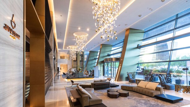 A spacious lobby with modern furniture, large windows, and decorative lighting. - Steigenberger Hotel Doha (Doha)