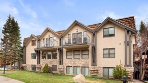 A modern two-story house with a stone facade, large windows, and a balcony. - BRIGHT, Renovated, In the Heart of Aspen Walkable (Aspen)
