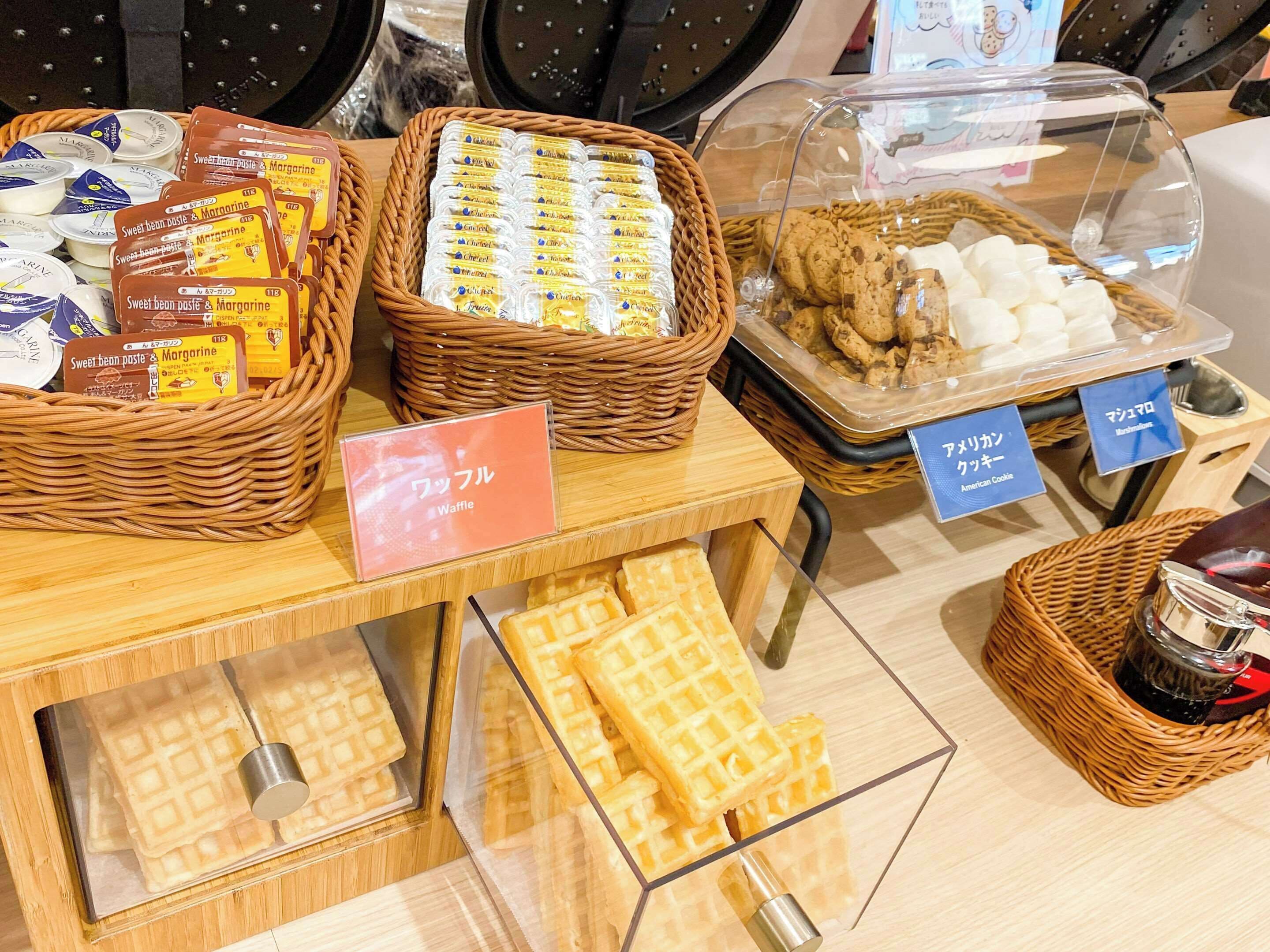 A bakery display with various baked goods including waffles, cookies, and sweet bean paste & margarine.