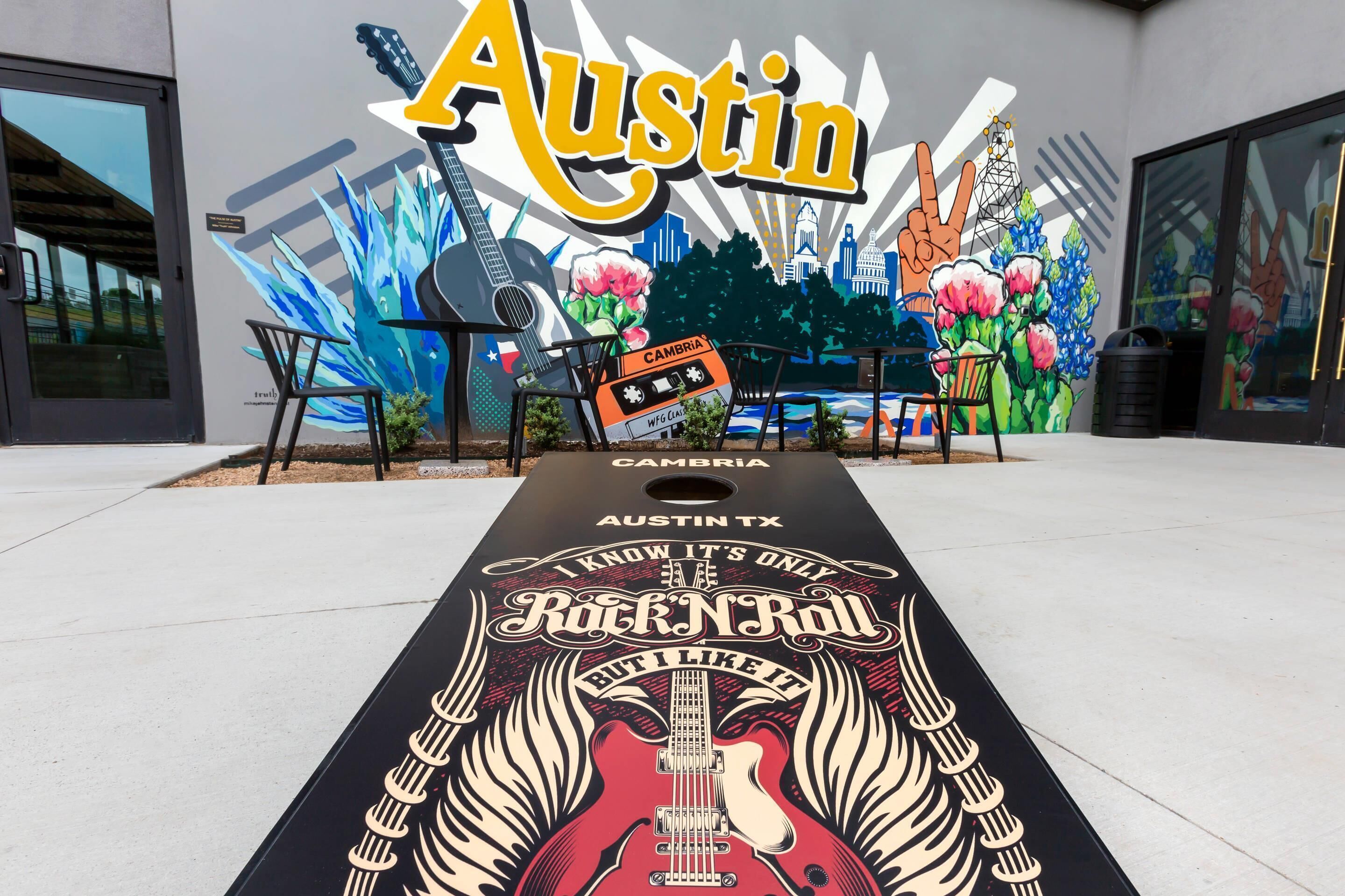 A mural with 'Austin' and 'Rock 'N' Roll' text, a guitar, and a clapperboard.