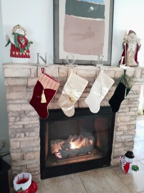 Ein Kamin mit darüber hängenden Weihnachtssocken.