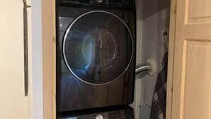 A laundry room with two stacked front-loading washing machines.