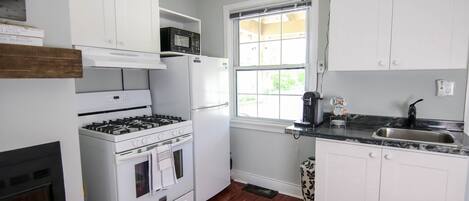 Fridge, coffee/tea maker, cookware/dishes/utensils