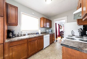 Enjoy cooking in this well-equipped kitchen with a dishwasher, stovetop, and window.