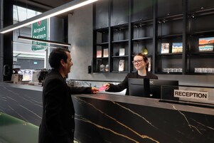 A reception desk with a sign indicating 'Airport Seaport Lane' and a 'RECEPTION' sign.
