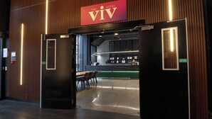 A hotel entrance with a reception desk, a seating area, and a sign indicating a fire door. - The Viv Hotel Wellington (Wellington)