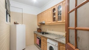 A compact kitchen with a refrigerator, stove, oven, and washing machine. - Residence Bouroud Hivernage 5376 (Marrakech)