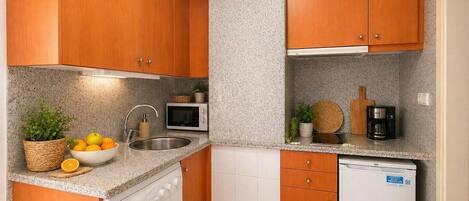 Fridge, microwave, coffee/tea maker, cookware/dishes/utensils
