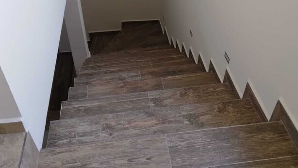 A staircase with wooden steps and white walls. - Downtown Oasis: Charming Two-Story Home in the Heart of Puerto Penasco, Mexico!  (Puerto Peñasco)