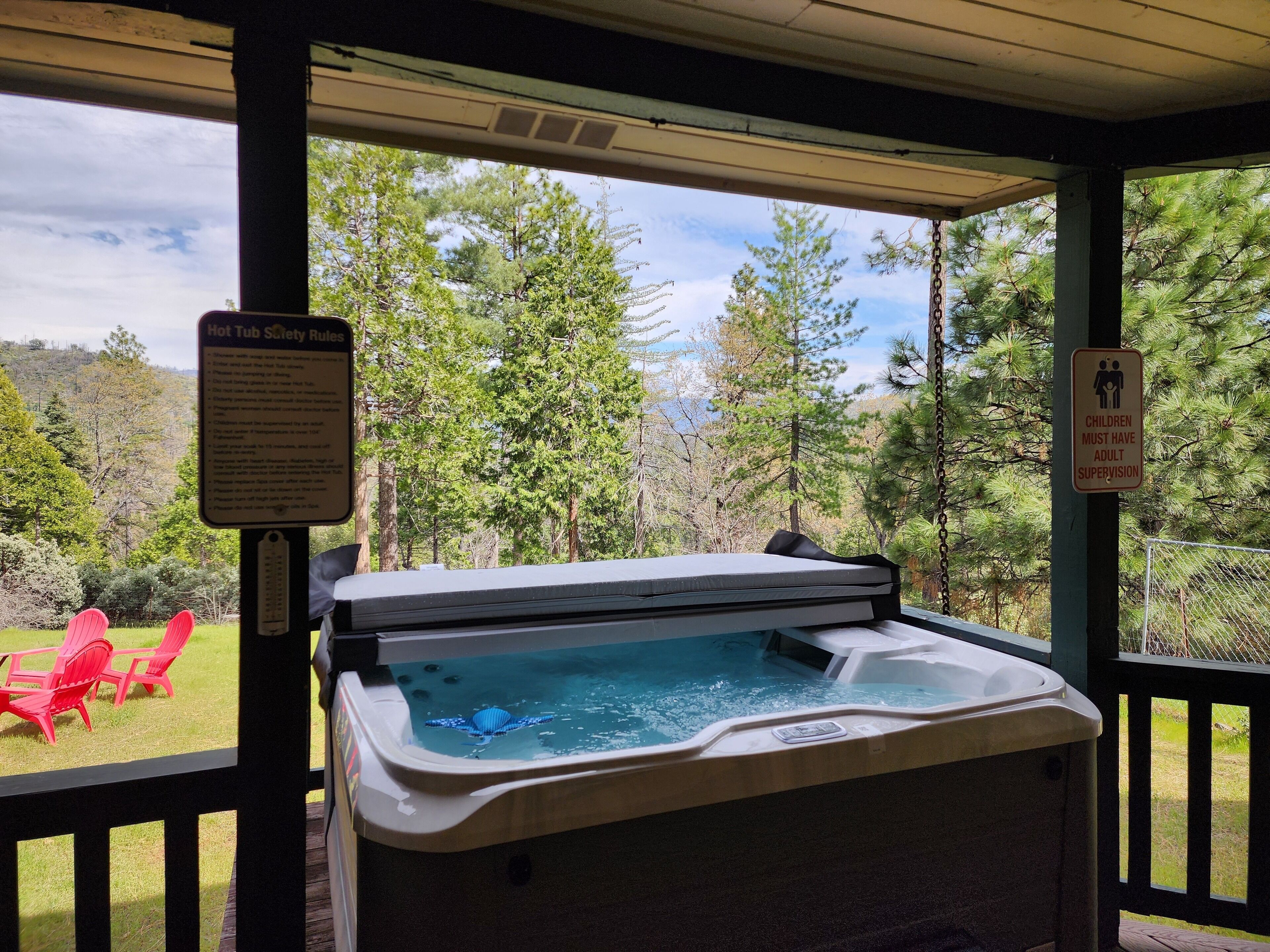 A hot tub with a safety sign and a sign indicating children must have adult supervision.