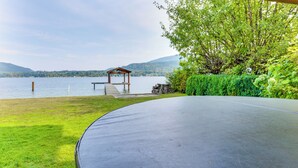 A covered outdoor area with a view of a lake and mountains. - Lake Whatcom House w/ Private Hot Tub + Dock (Bellingham)