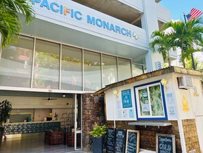 A coffee shop with a sign reading 'PACIFIC MONARCH' and a menu board outside. - "STEPS AWAY FROM THE WAIKIKI BEACH WITH OCEAN VIEW" (Honolulu)