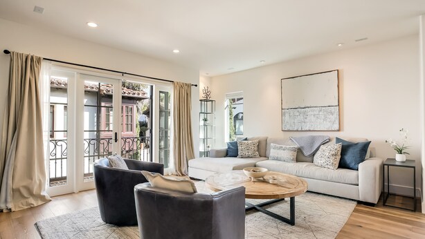 A spacious living room with a sofa, two armchairs, a coffee table, and a side table. - "Casa Playa" in the heart of West Beach - impeccably remodeled, with A/C and 2 car garage! (Santa Barbara)