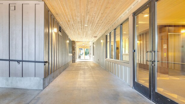 A long, narrow corridor with a wooden ceiling and glass doors on one side. - Half-Mi to Payette Lake: Dtwn McCall Condo! (McCall)